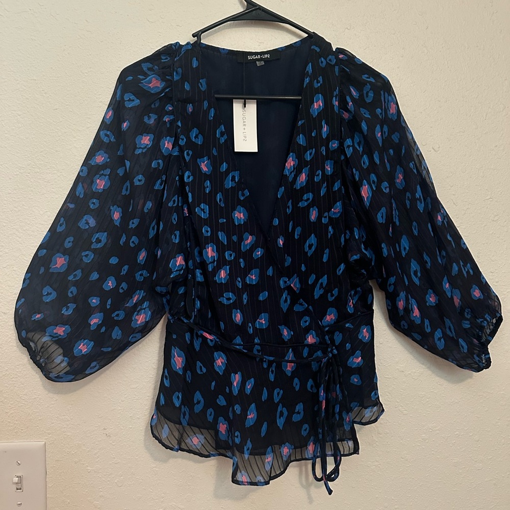 Button closure, tie detail, sheer arms